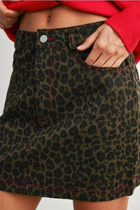 Olive green leopard print mini skirt with red stitching, perfect for women’s boho chic clothing
