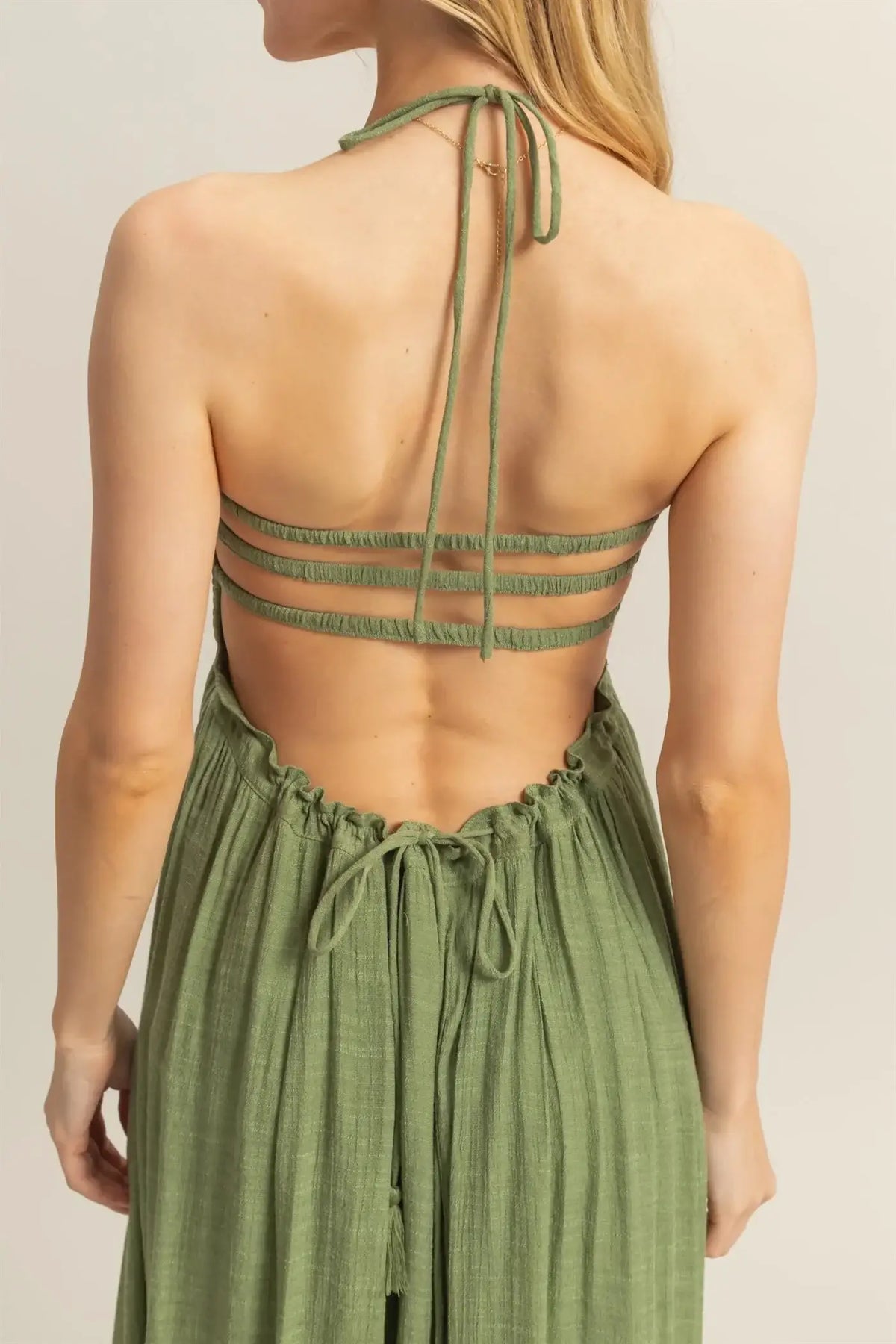 Olive green open-back maxi dress with smocked bodice and tiered hem design