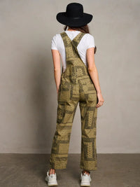 Olive green patterned overalls over a white t-shirt in women’s boho chic clothing