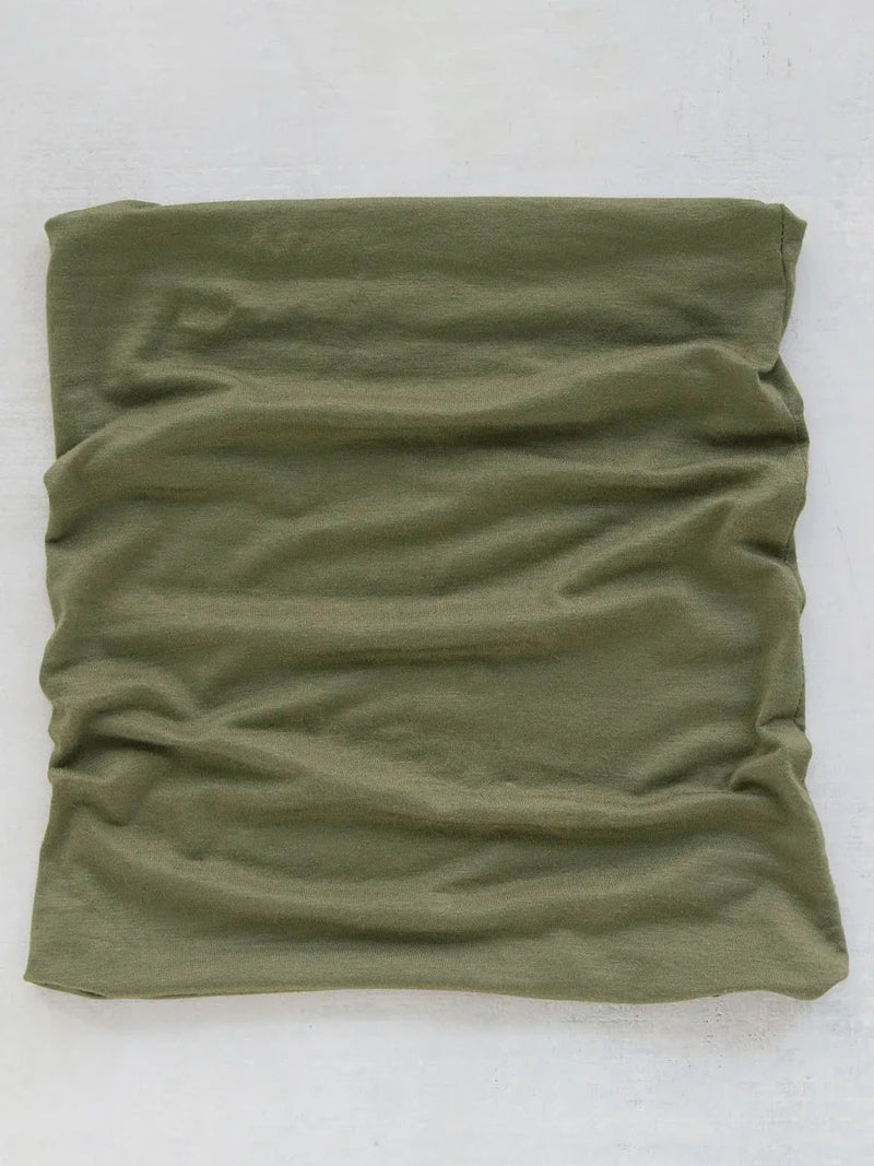 Olive green scarf folded on a white surface, featured as a Boho Bandeau accessory