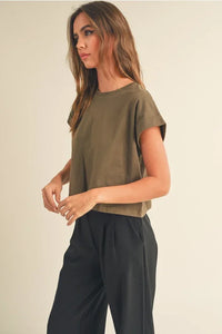 Olive green round neck cuffed short-sleeved top with black pleated trousers