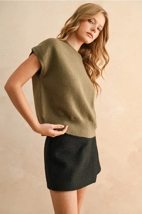Olive green loose fit short sleeve sweater top with black skirt