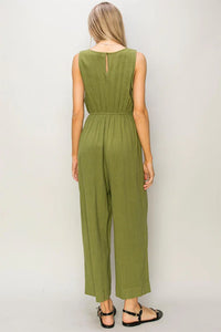 Olive green sleeveless linen jumpsuit with wide-leg pants for a flowy boho style