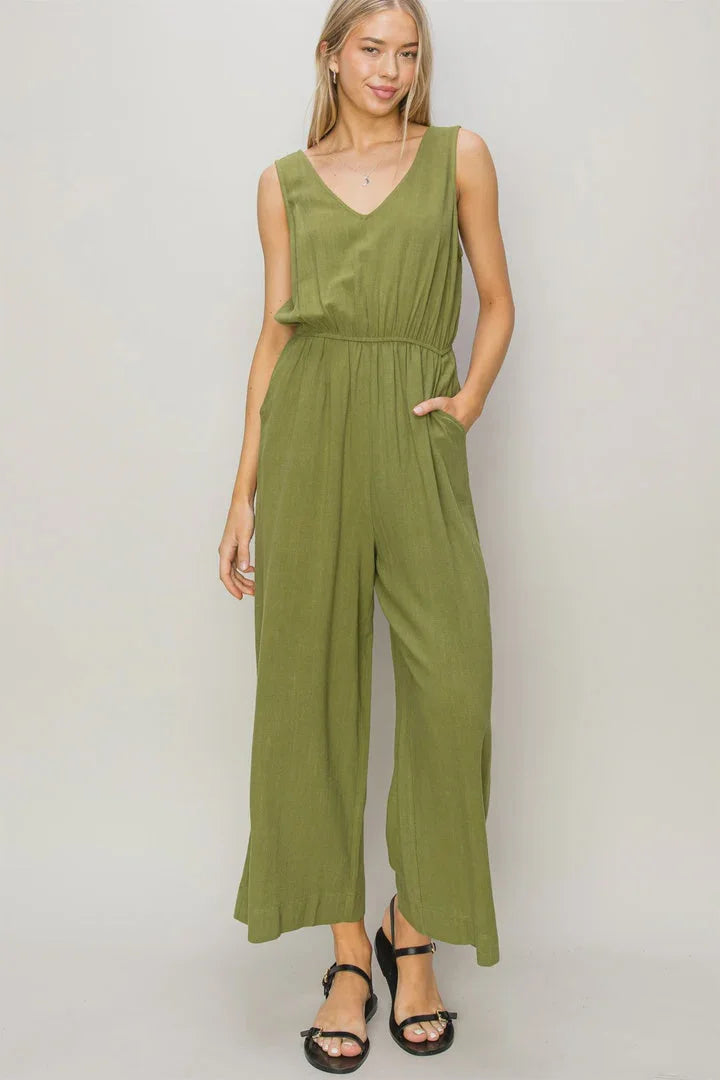 Olive green linen jumpsuit with wide-leg pants and a V-neckline, perfect for boho style