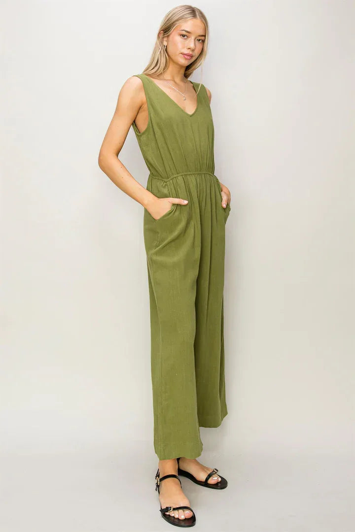 Olive green sleeveless linen jumpsuit with V-neck and flowy wide-leg pants