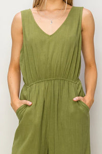 Olive green linen jumpsuit with V-neck and elastic waistband for a flowy boho look