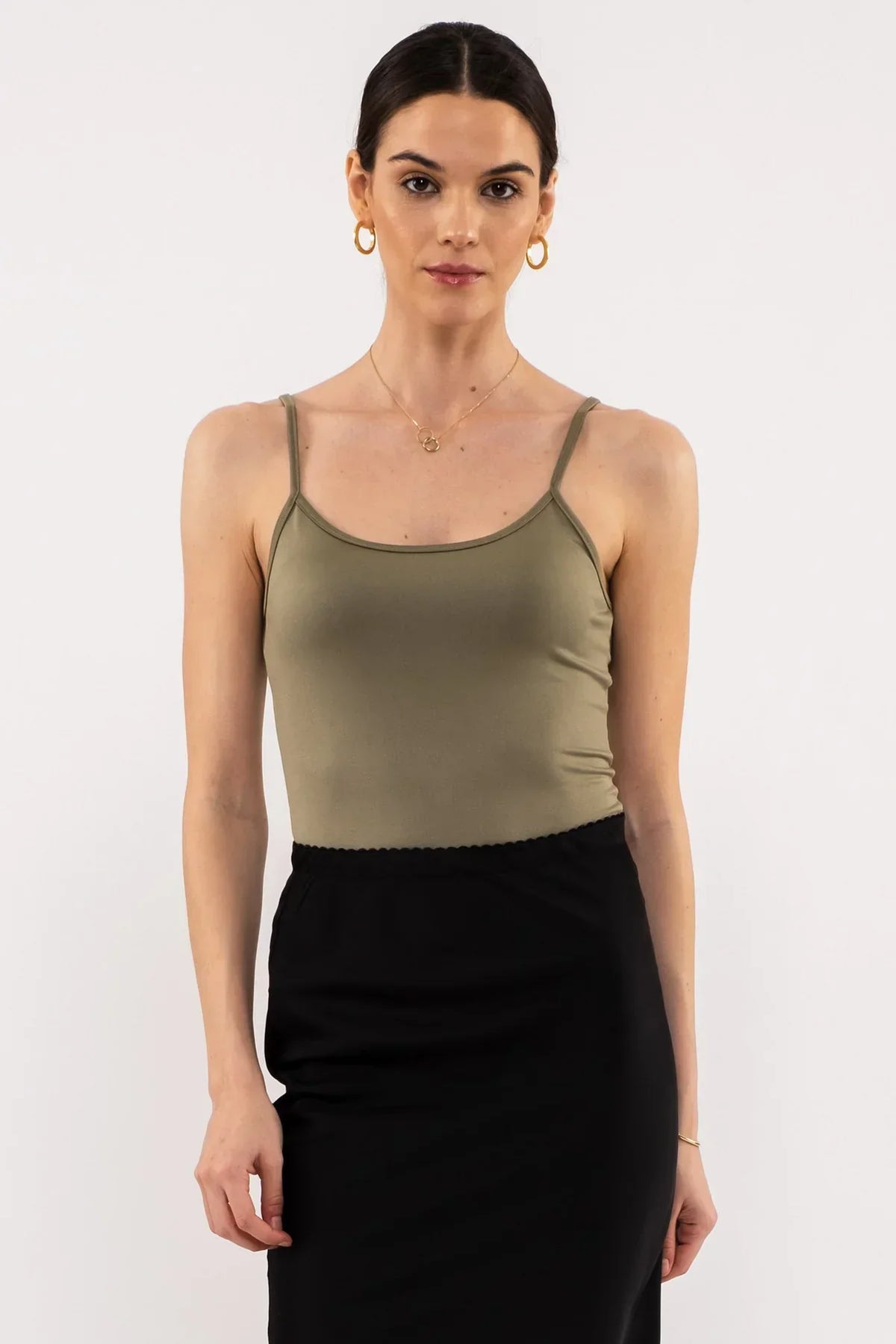 Olive green spaghetti strap tank top styled with a black skirt from Shop Daisy