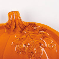 Orange ceramic pumpkin plate with intricate leaf design, perfect for boho decor