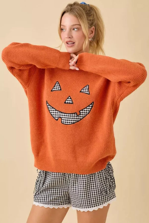 Orange knit Pumpkin Face Patchwork Sweater with gingham Jack-o’-lantern features