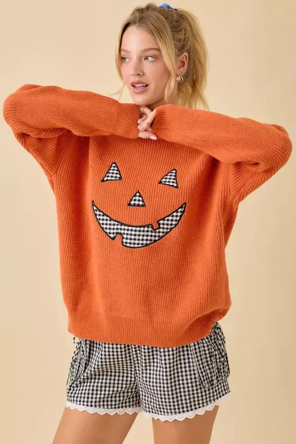 Orange knit Pumpkin Face Patchwork Sweater with gingham Jack-o’-lantern features