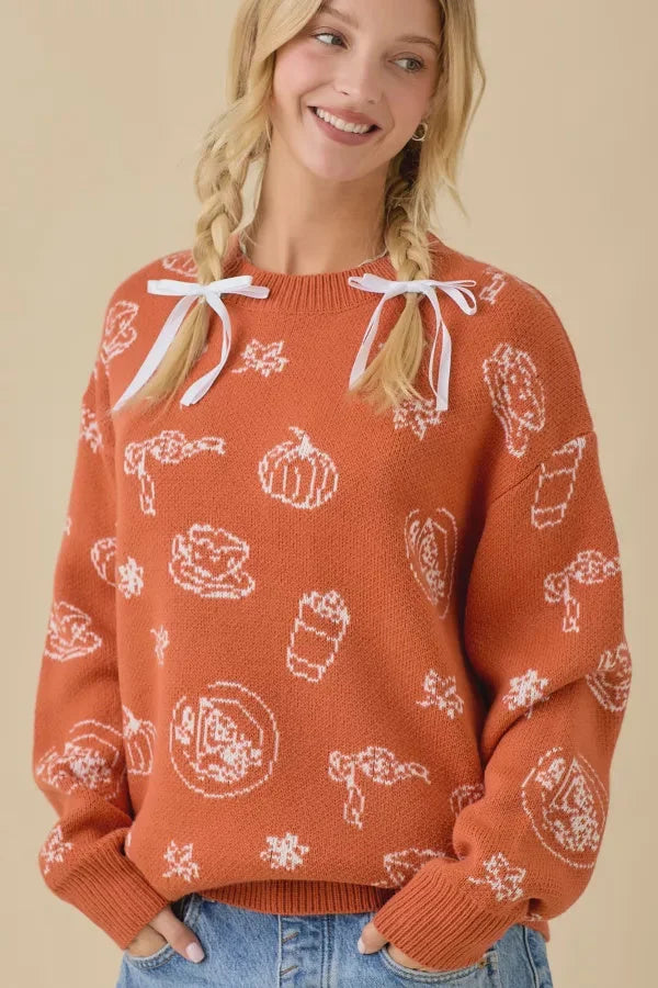 Orange pumpkin spice printed sweater with white pumpkin, coffee, and leaf patterns