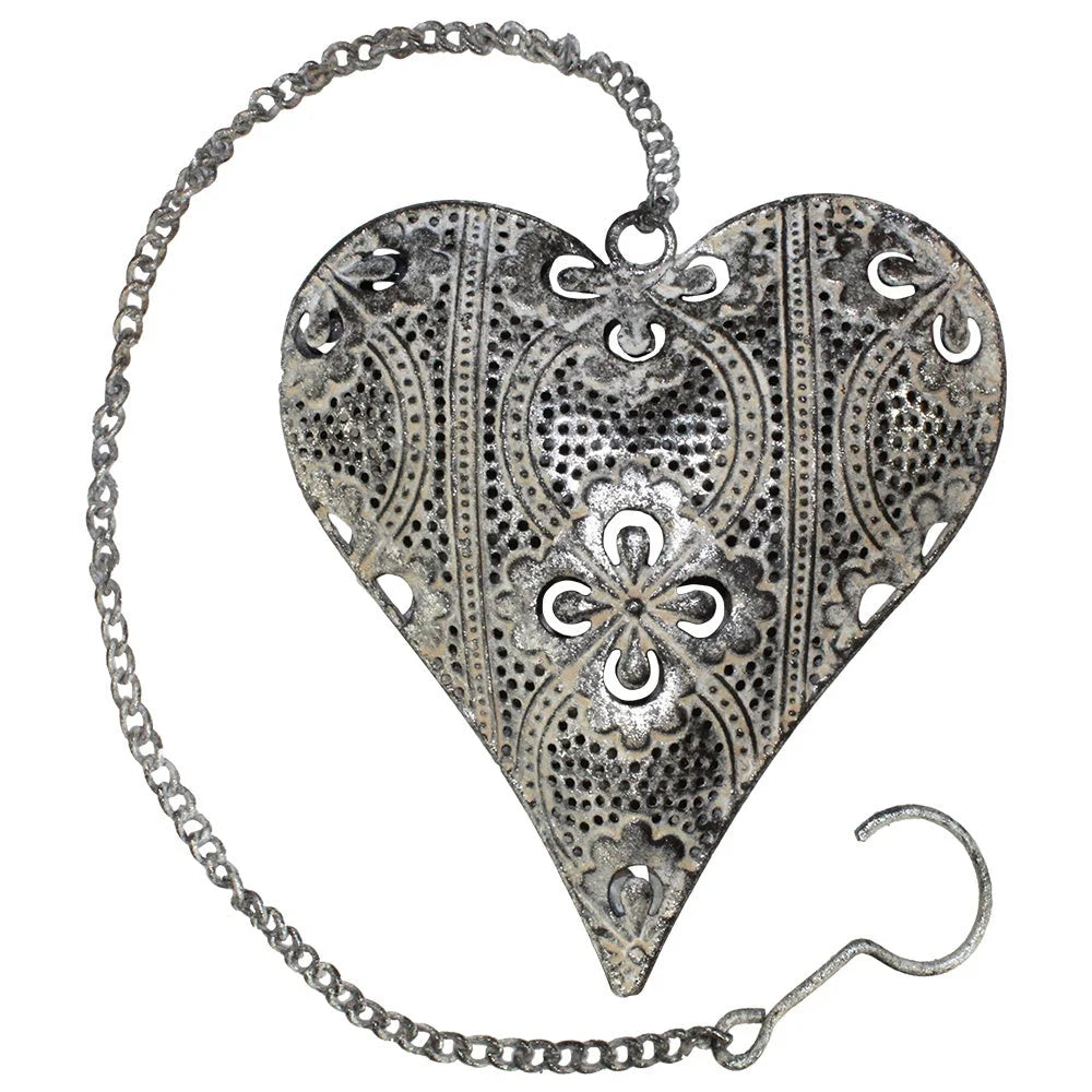 Ornate metal heart pendant with floral designs on a chain for women’s boho chic clothing