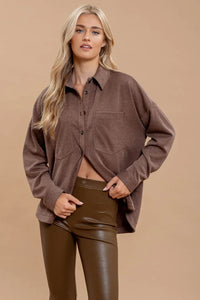 Oversized pinstripe button down shacket worn open over a crop top for casual style