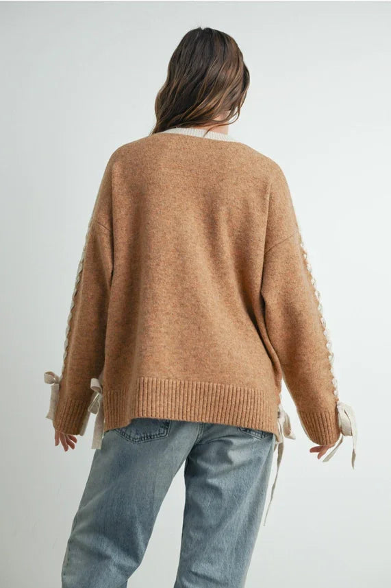 Oversized caramel-brown crew neck long sleeve pullover sweater with cream ribbon accents