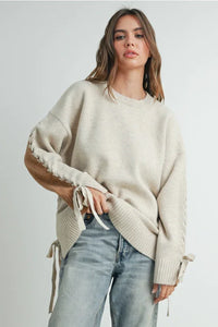 Oversized cream crew neck long sleeve pullover sweater with lace-up sleeve details