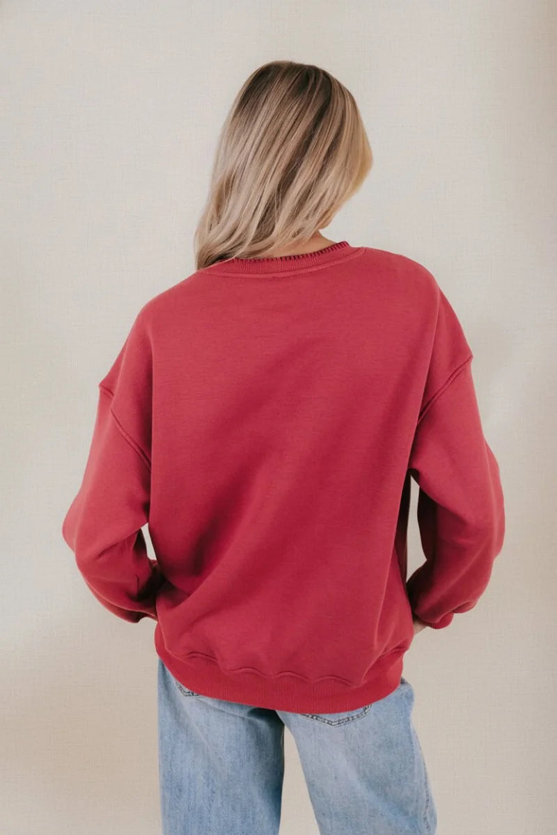 Oversized long sleeve Christmas graphic sweater in maroon with ribbed cuffs