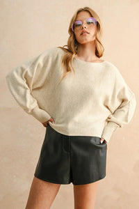 Oversized off-white boat neck sweater with ribbed cuffs, stylish boat neck design