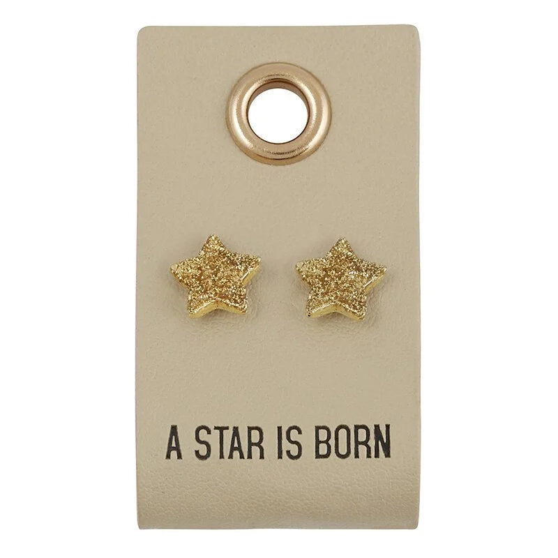 Gold glittery star-shaped stud earrings on a card, perfect for boho flowy styles