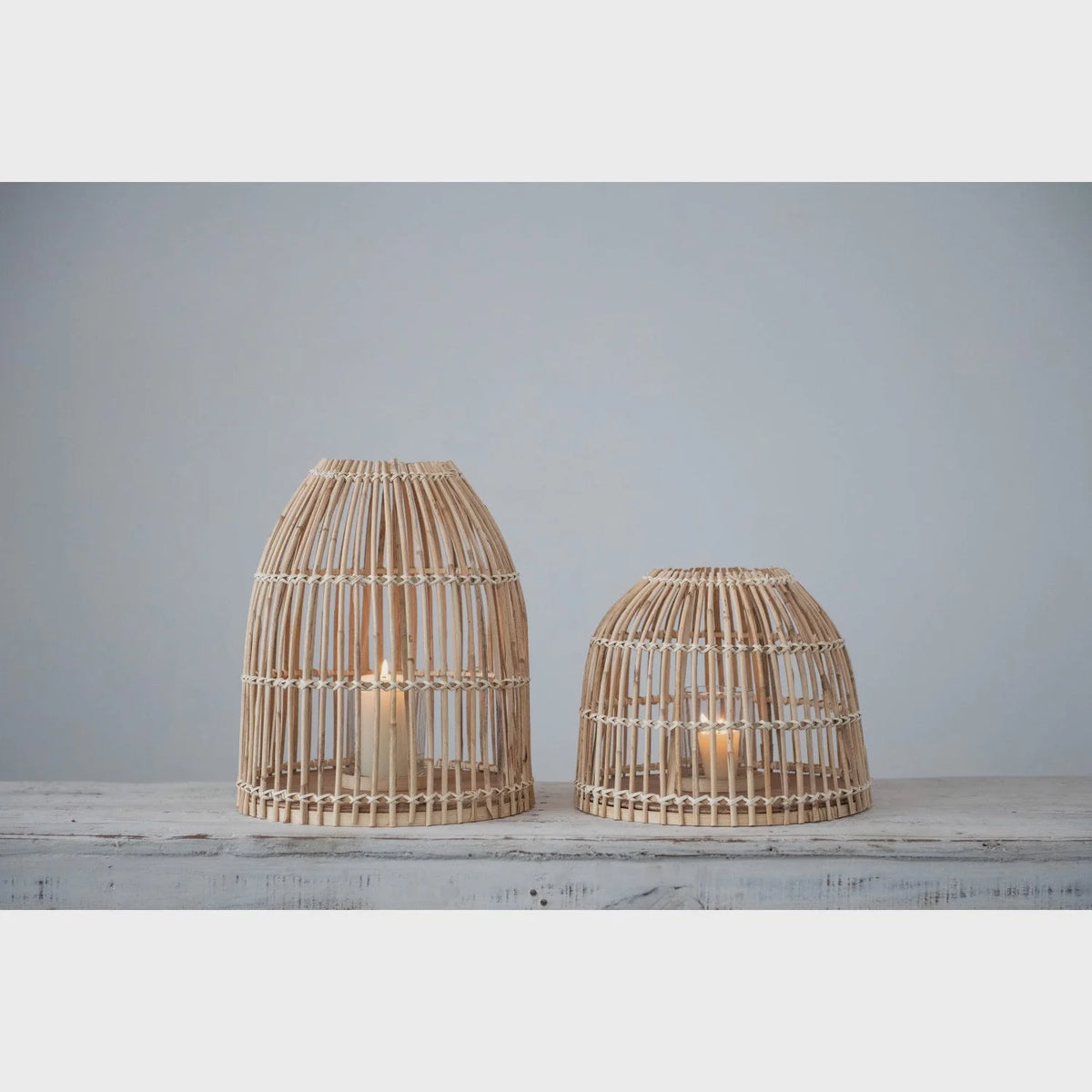 Wooden bird cages with candles in Bamboo Lanterns with glass inserts, showcasing boho decor