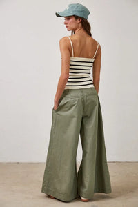Pale green wide-leg pants with striped removable strap tube tank top and baseball cap