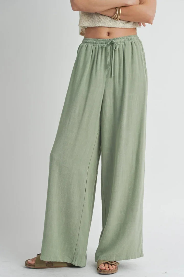 Pale green wide-leg SUGARLOAF LINEN PANTS with drawstring waist for stylish comfort