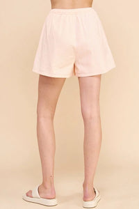 Pale pink high-waisted Adjustable Tie Shorts in stripe cotton blend style on displayed model