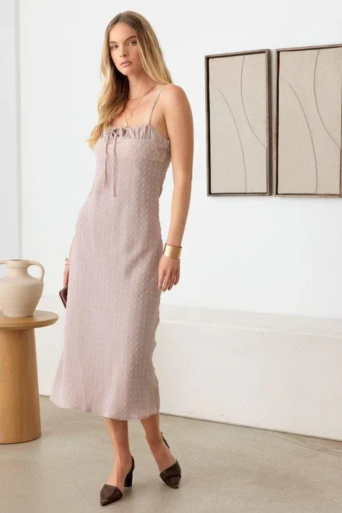 Pale pink polka dot spaghetti strap midi dress with a subtle texture for a boho look