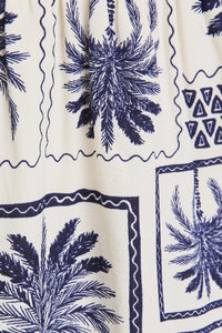 Palm tree patterned fabric featured in HALTER NECK ABSTRACT PRINT DRESS with an abstract print design