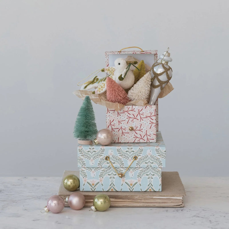 Pastel blue and pink printed gift boxes with berry dove patterns
