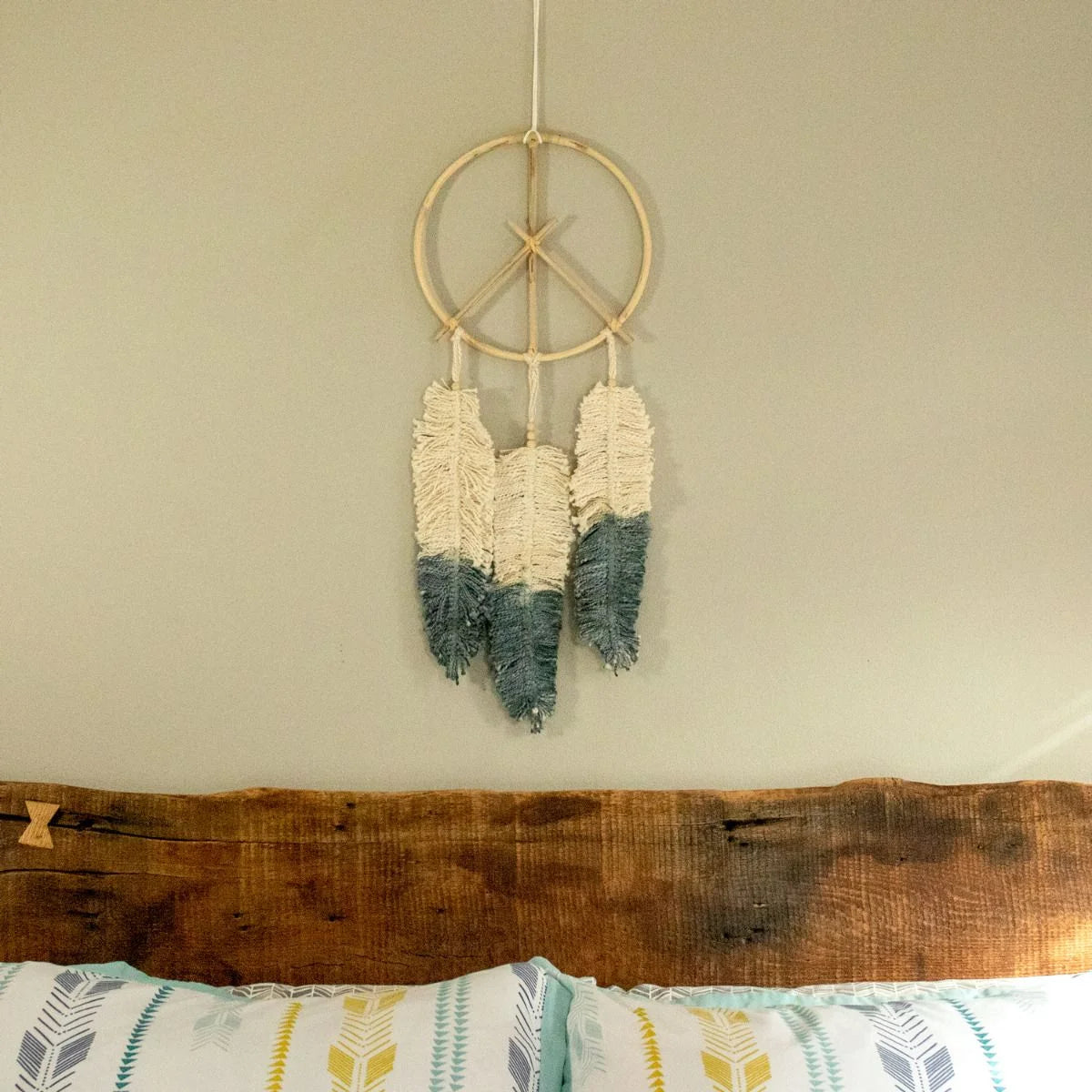 Peace sign dream catcher crafted from natural cane with white and teal feathers