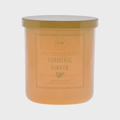 Peach-colored Turmeric Ginger Candle jar with gold lid, perfect for boho free spirit decor