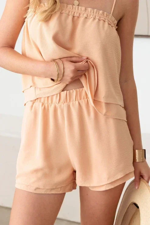 Peach-colored sleeveless romper with ruffled details for a boho, free spirit look