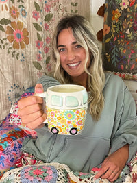 Smiling person holds hand sculpted boho FOLK ART COFFEE MUG - DAISY THE VAN