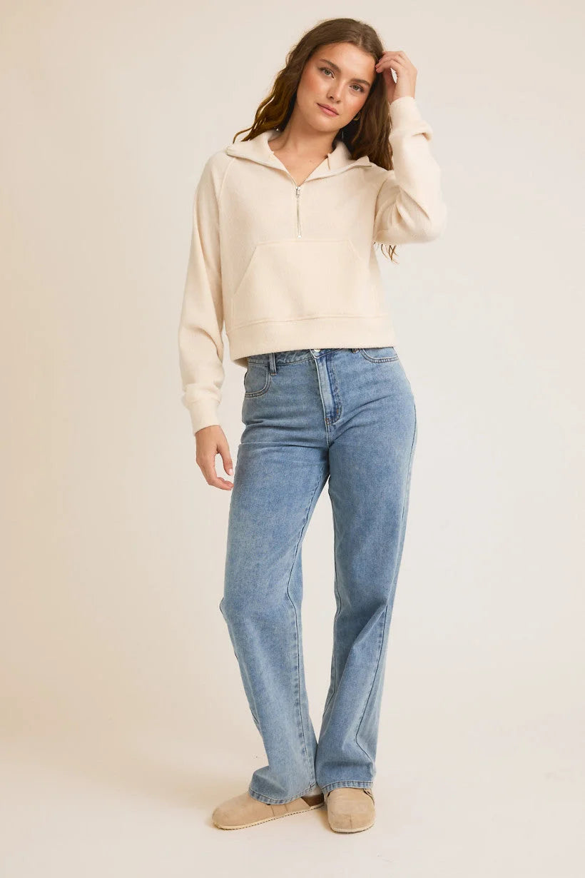 Person in cream cropped sweater and blue jeans, size small from Shop Daisy women’s boho chic clothing