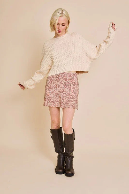 Person in cream Round Neck Dolman Sleeve Cable Sweater Top with floral skirt and tall boots