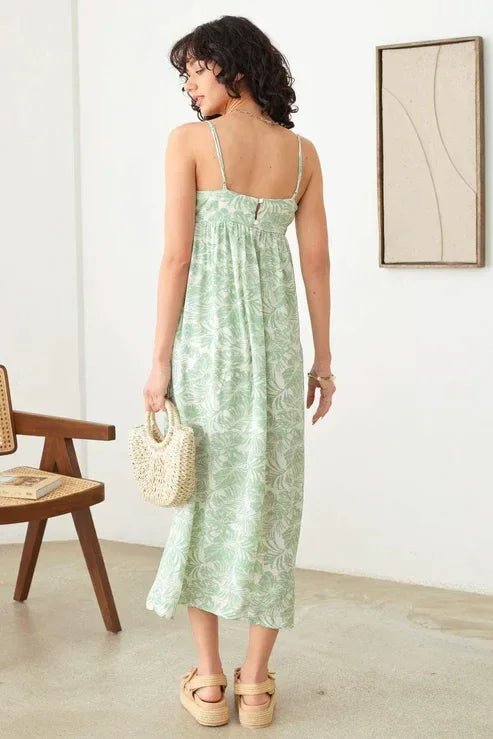 Person wearing a Sleeveless Shirring Tropical Print Adjustable Strap Maxi Dress