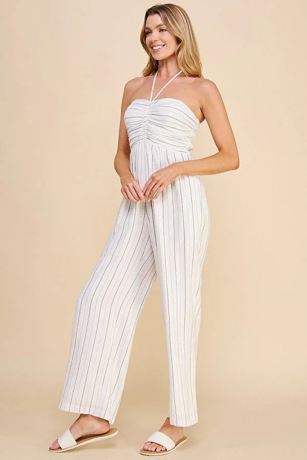 Model showcasing the Halter Neck Spaghetti Tie Ruched Lined Jumpsuit in action