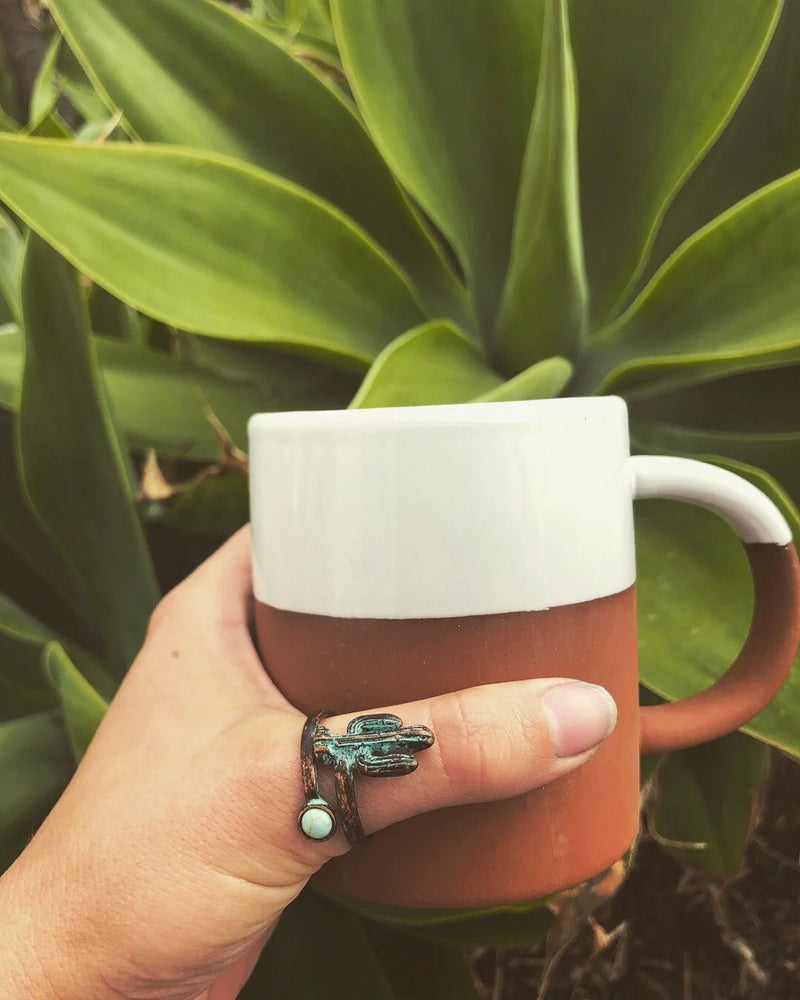 Person holding a mug with a frog while showcasing a Cactus Wrap Ring