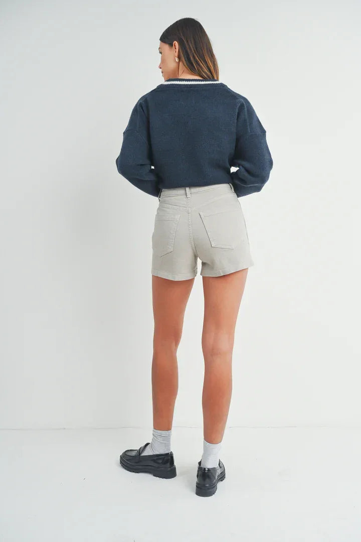 Person in navy blue sweater and beige shorts showcasing HR UTILITY CARGO SHORT, boho style