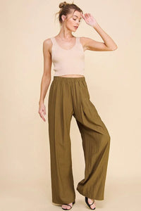 Person wearing olive flowy textured soft pull-on pants showcasing versatile style