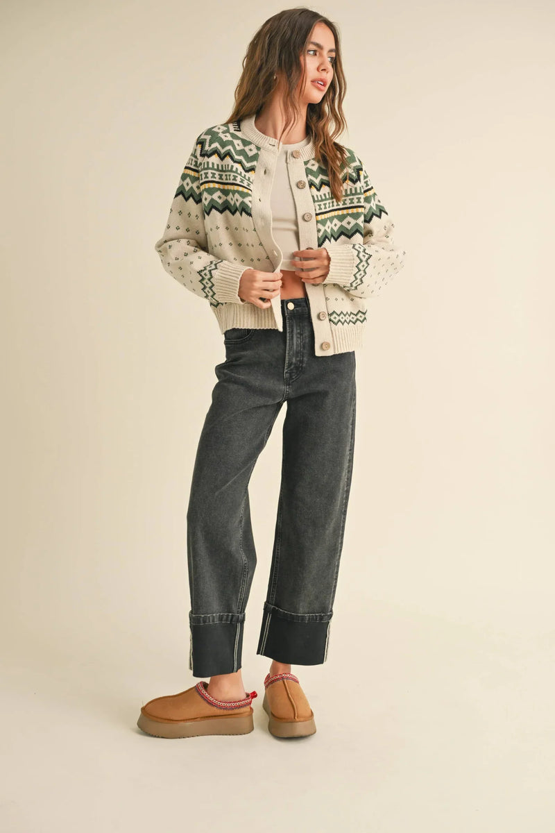 Person in a patterned knit cardigan and wide-leg jeans, exemplifying women’s boho chic clothing