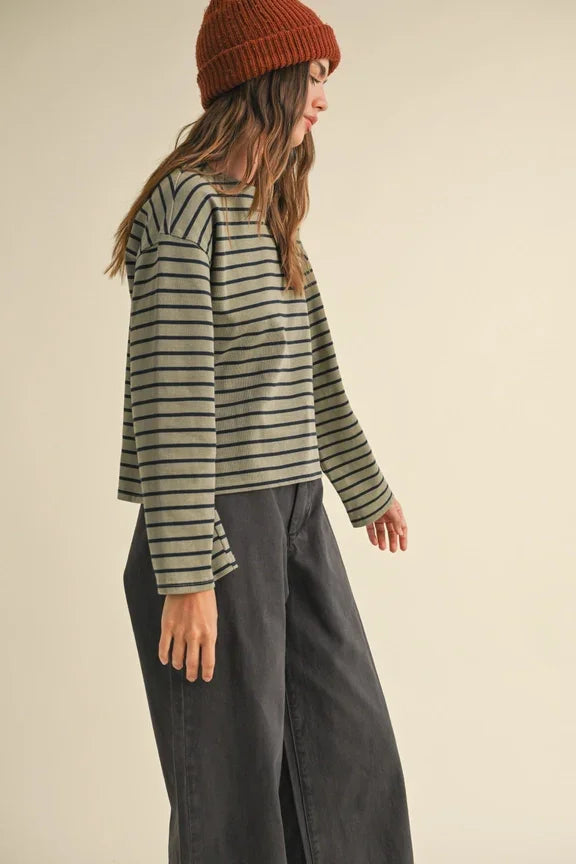 Person in striped pattern long sleeve top and wide-leg pants, showcasing women’s boho chic clothing