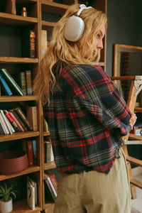 Person in white headphones models CORY Cropped Plaid Button-Down Shirt with frayed hem