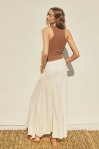 Person wearing a white linen Flared Maxi Skirt from the Heaven Sent collection