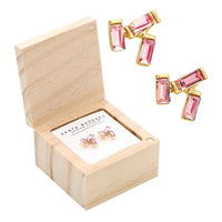 Pink and gold treasure box earrings displayed in a wooden box for the TREASURE BOX EARRINGS collection