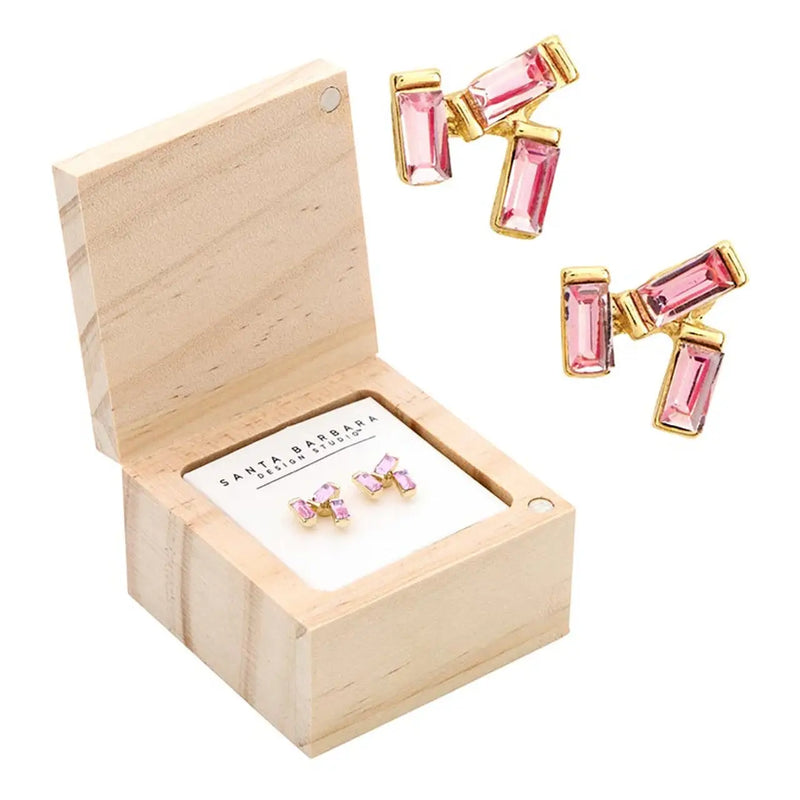 Pink and gold treasure box earrings displayed in a wooden box for the TREASURE BOX EARRINGS collection