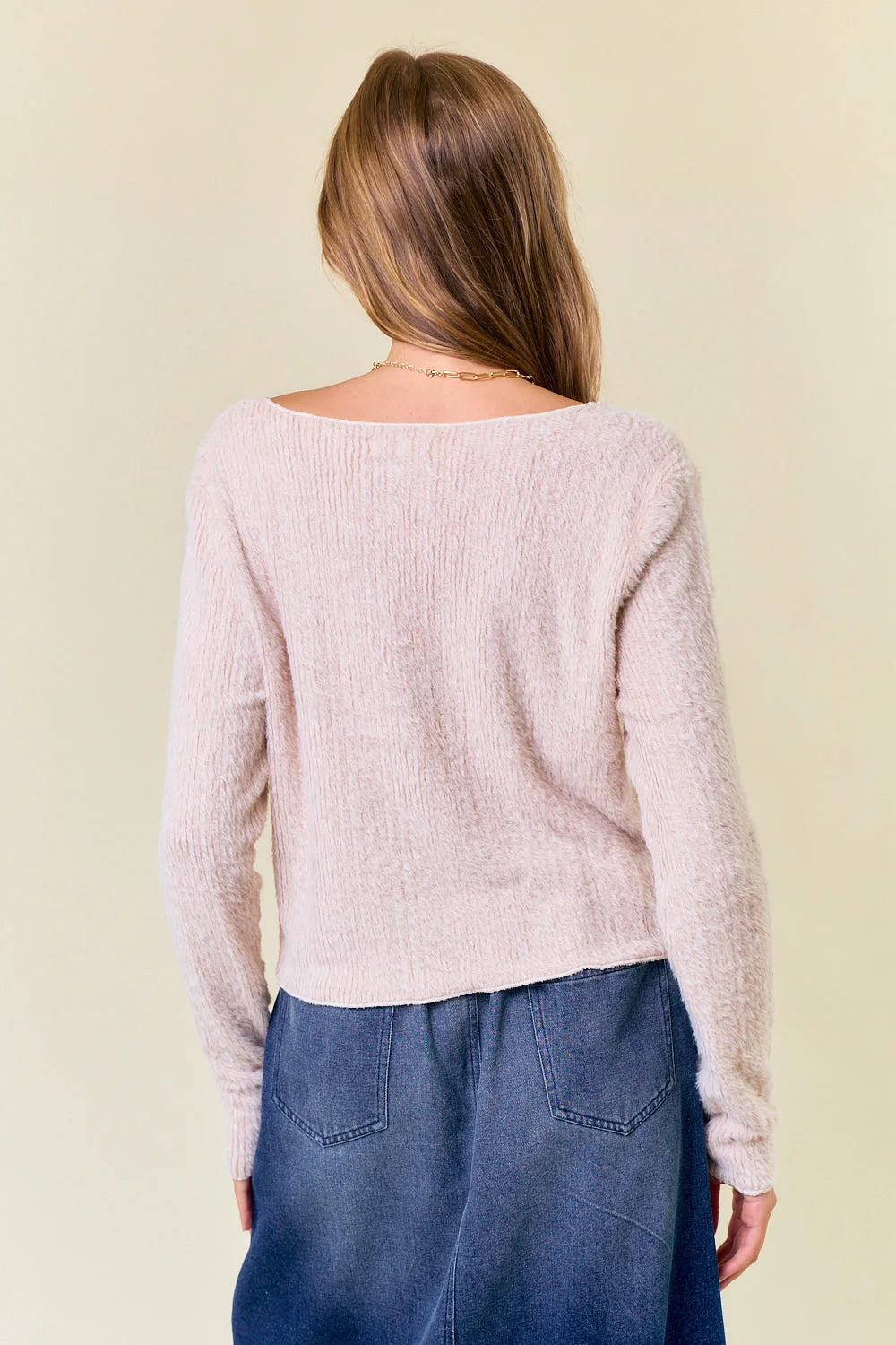 Back view of a pink fuzzy knit sweater from the SOFT FUZZY KNIT collection at Shop Daisy