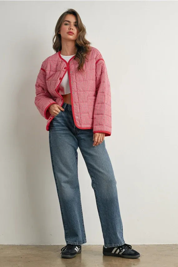 Pink buttoned quilted puffer jacket with red trim and white buttons