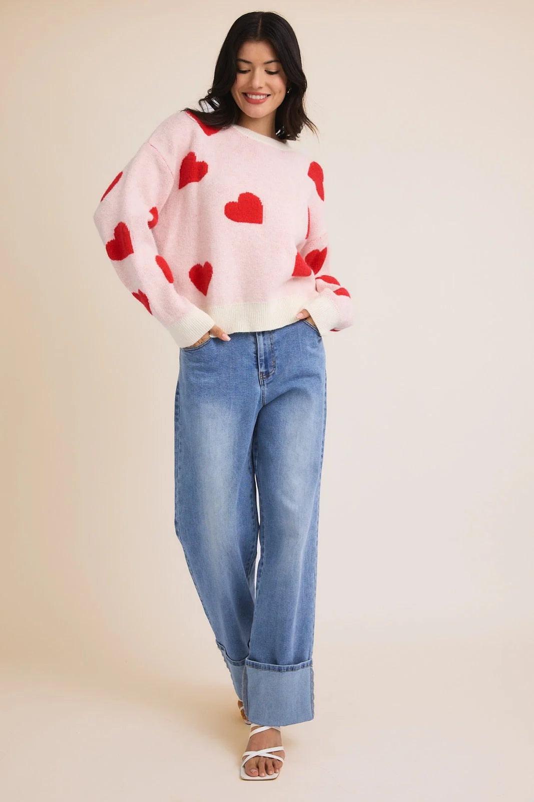 Pink heart patterned sweater with cuffed wide-leg jeans, part of Shop Daisy’s women’s boho chic clothing