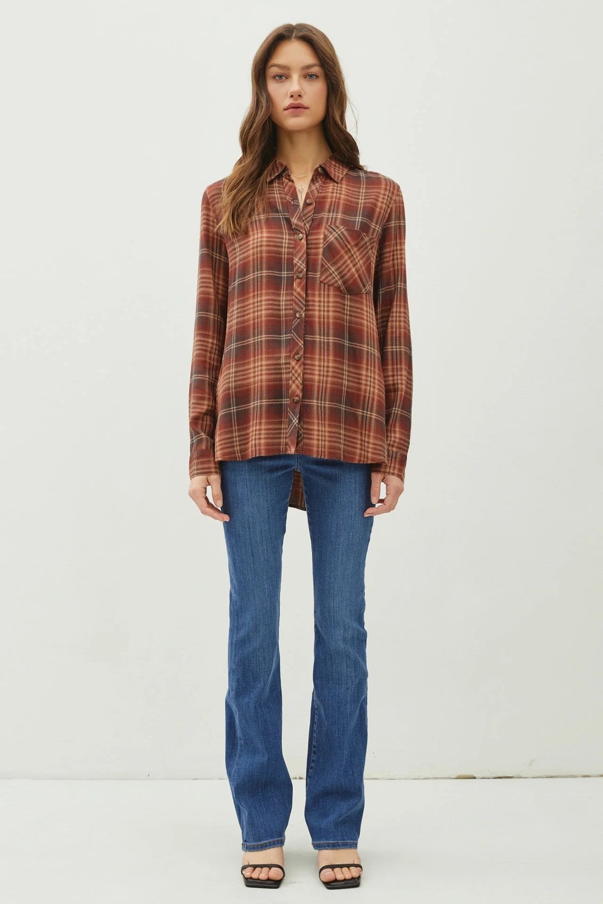 Plaid classic button flannel shirt in autumn colors styled with blue jeans